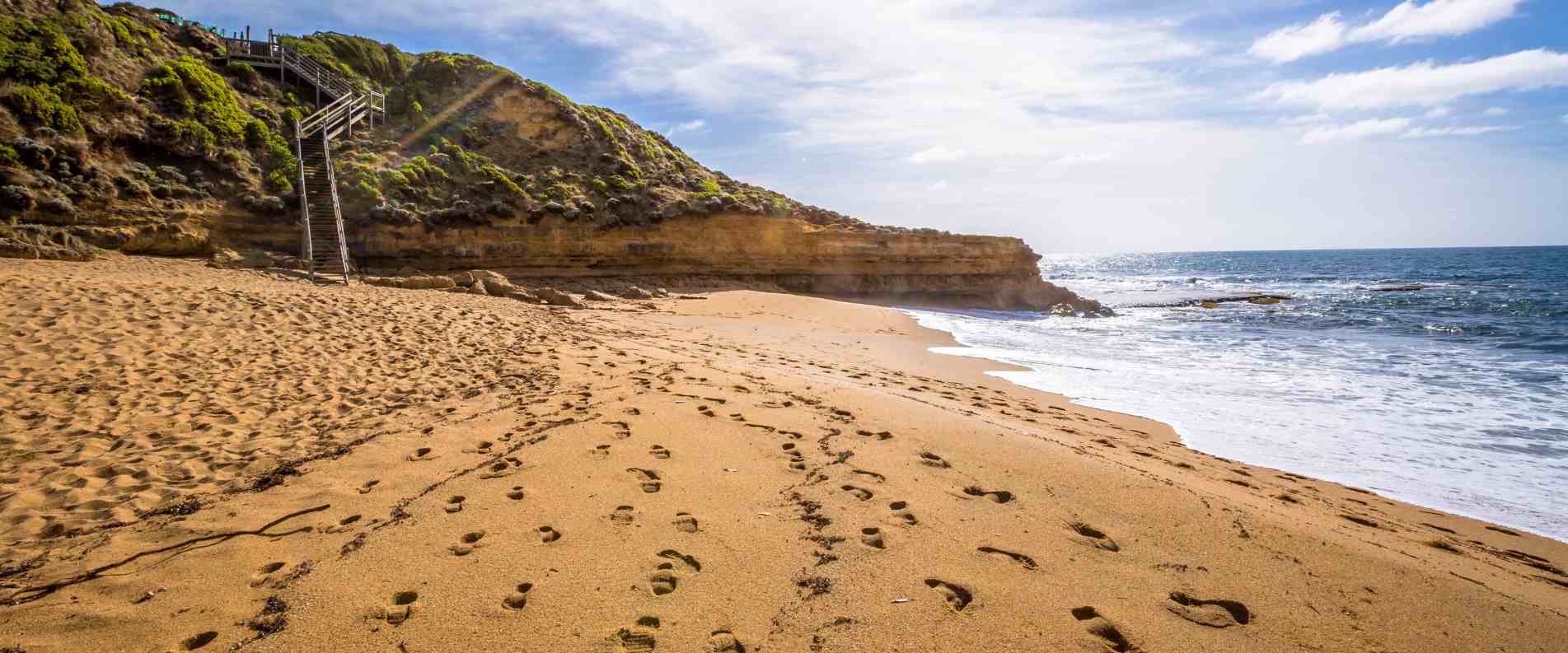 Footprints in the sand on bells beach
