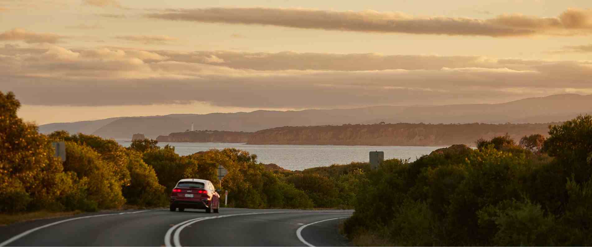 Car driving down coastal road